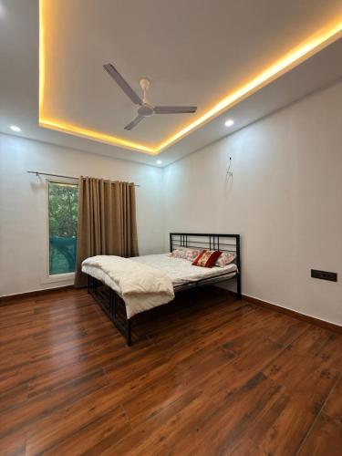 a bedroom with a bed with a ceiling at Luxurious Farm in Greater Noida