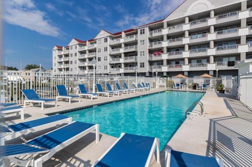 a swimming pool with lounge chairs and a hotel at White Marlin 209B in Ocean City