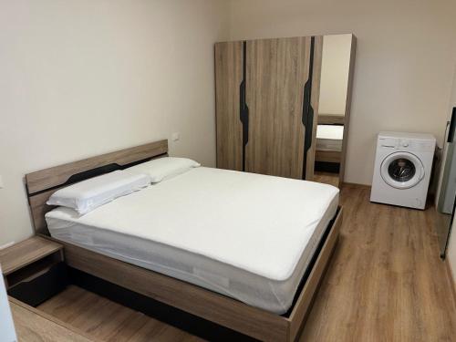a bedroom with a bed and a washing machine at Salsedine house in Punta Marina
