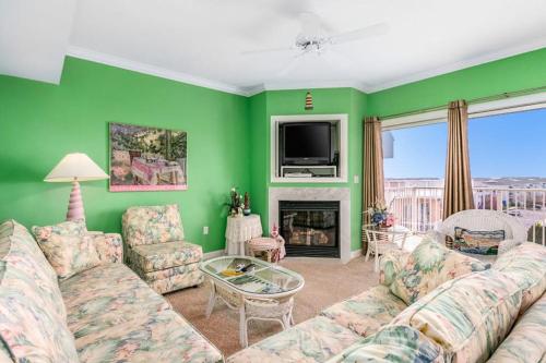 a living room with a couch and a tv at Lorelei I 404 in Ocean City