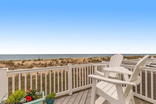 a deck with chairs and a view of the beach at Beach Village 6 in Ocean City