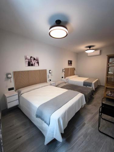 a bedroom with two beds in a room at AniCa IV De Cine in Tomelloso