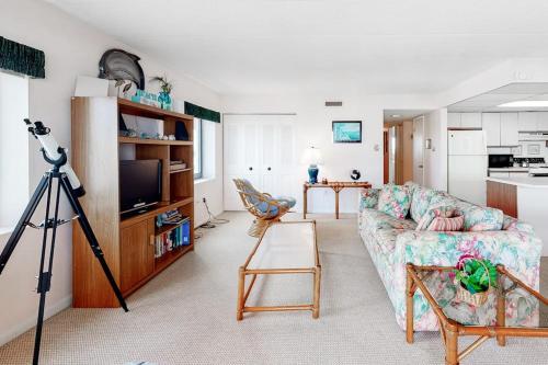 a living room with a couch and a camera at Sunny Sands 401 in Ocean City
