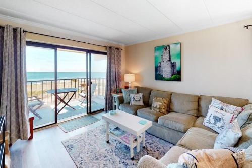 a living room with a couch and a table at Waikiki 102 in Ocean City