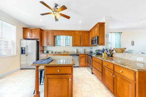 a kitchen with wooden cabinets and a ceiling fan at Saint Louis Ave, Unit D in Ocean City