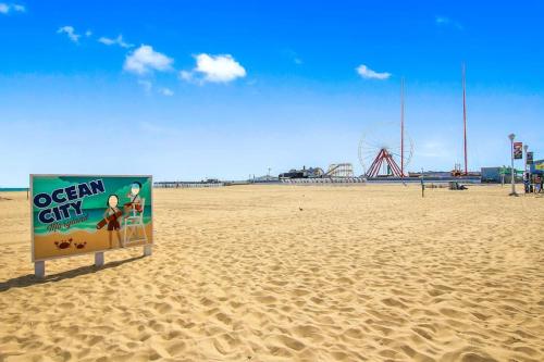 a sign in the sand on a beach at Belmont Towers 410 in Ocean City