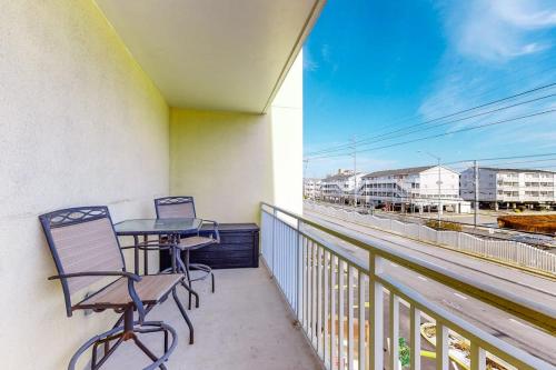 a balcony with two chairs and a table on it at Sunset Bay III 313 in Ocean City