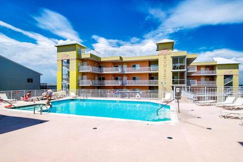 a swimming pool in front of a hotel at Sunset Bay III 313 in Ocean City