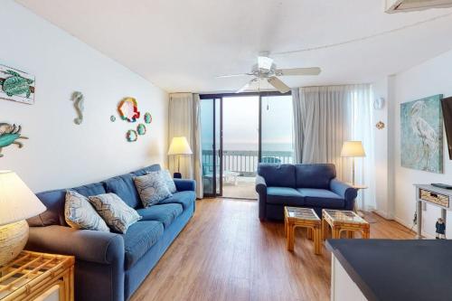 a living room with a blue couch and a table at Century I 2521 in Ocean City