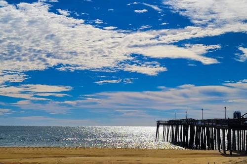 a pier on the beach with the ocean and clouds at 900 Philadelphia in Ocean City