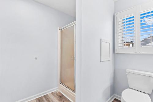 a bathroom with a shower and a toilet at Waterfront Home with OC Skyline Views in Ocean City