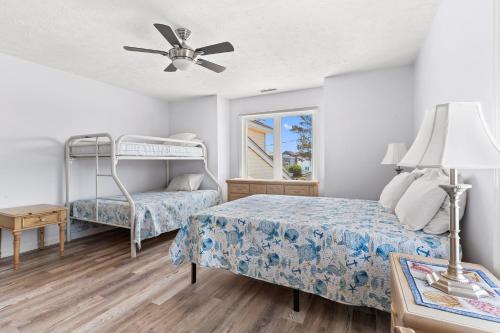 a bedroom with two beds and a ceiling fan at Waterfront Home with OC Skyline Views in Ocean City