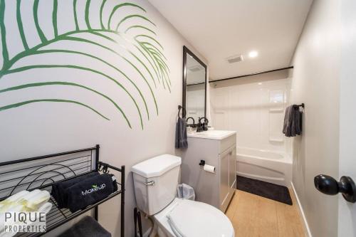 a bathroom with a toilet and a sink and a tub at Modern Urban Escape -King Bed -Pet Friendly - Free Parking & Netflix - Fast Wi-Fi in Edmonton