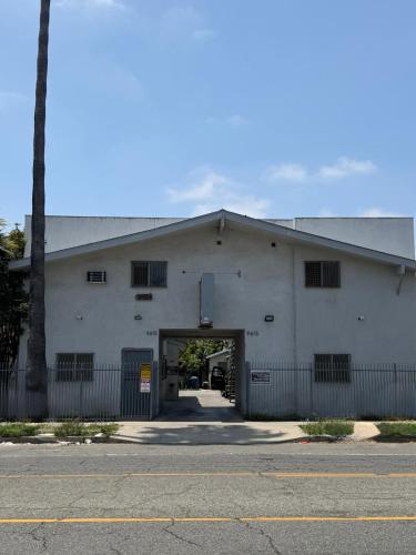 a large white building with a tunnel in it at Casa Motel in Los Angeles