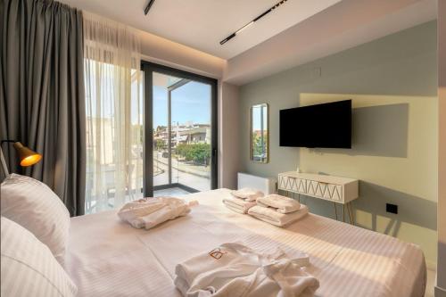 a bedroom with a bed with two towels on it at PREVEZA VILLA center in Preveza