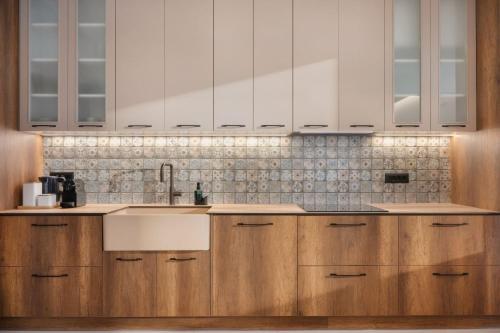 a kitchen with wooden cabinets and a sink at PREVEZA VILLA center in Preveza
