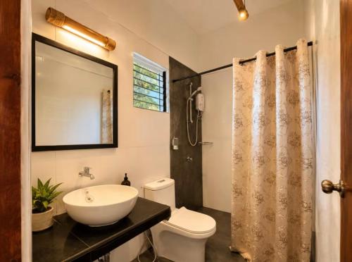 a bathroom with a sink and a toilet at Anaiah Garden Resort in Moalboal