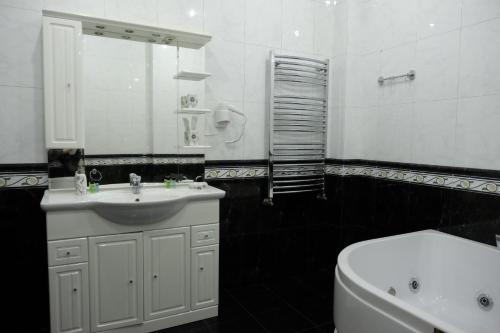 a black and white bathroom with a sink and a toilet at S&L Boutique Hotel in Tbilisi City