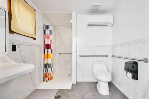 a bathroom with a toilet and a sink and a shower at The Moon Hotel in Williams