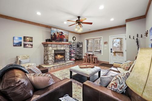 a living room with leather furniture and a fireplace at License to Chill Boone in Banner Elk