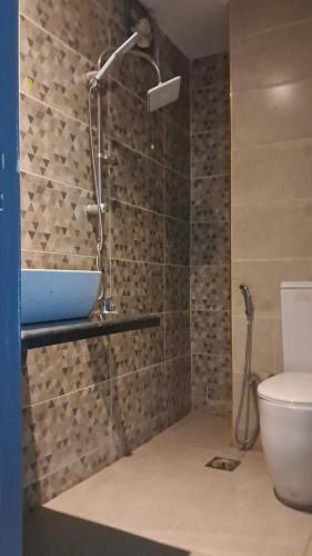 a bathroom with a shower and a sink and a toilet at Hayat Pyramids House DBL 59S in ‘Ezbet `Abd el-Ḥamîd