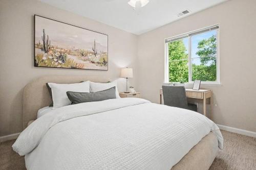 a bedroom with a bed and a desk and a window at Modern 3BR Davis Retreat in Davis