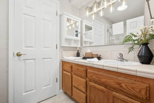 a bathroom with a sink and a white door at Modern 3BR Davis Retreat in Davis