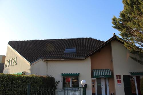 a white building with a black roof at Villa Hotel in Troyes