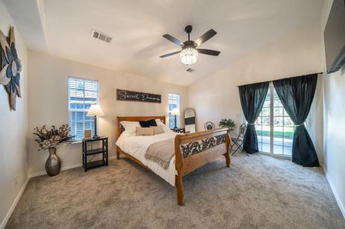 a bedroom with a bed and a ceiling fan at Martinique in Redding