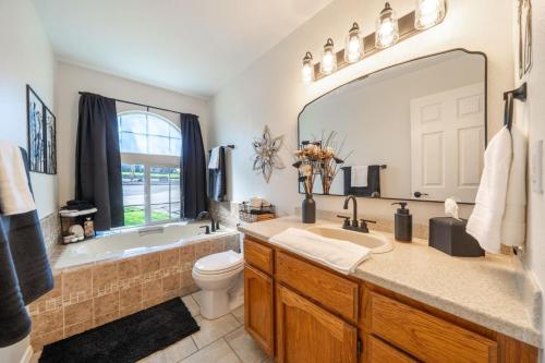 a bathroom with a tub and a toilet and a sink at Martinique in Redding