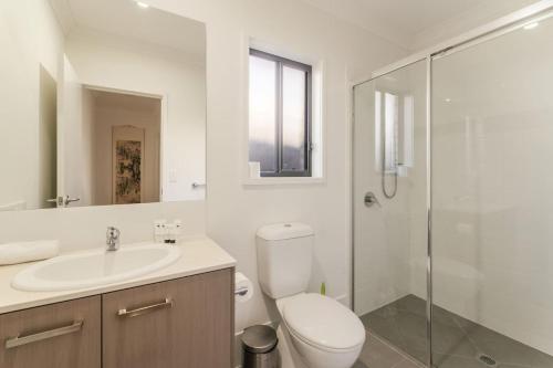 a bathroom with a toilet and a sink and a shower at Spacious 4B Near Logan with Parking in Marsden