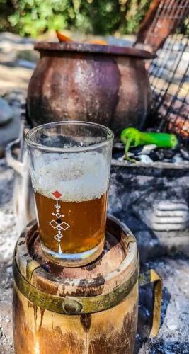 a glass of beer sitting on top of a barrel at Taddart n Dades in Boumalne Dades