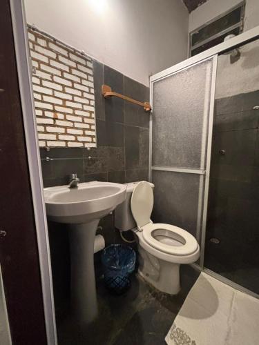 a bathroom with a toilet and a sink at Cacau Biruta in Itacaré