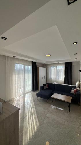 a living room with a blue couch and a table at The Brothers Suite Dalaman in Dalaman