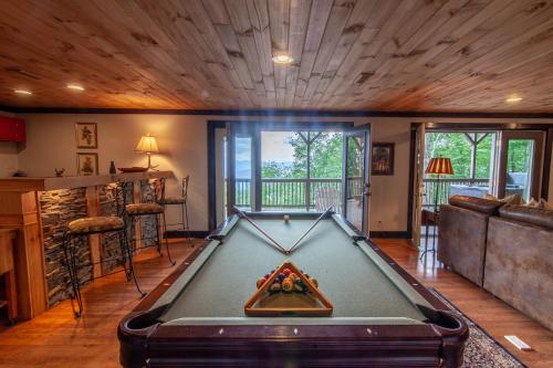 a pool table in the middle of a living room at Pinnacle View Lodge in Boone