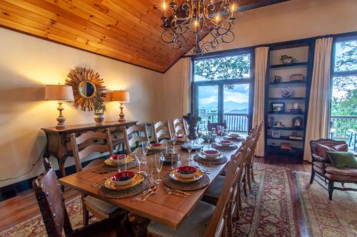 a dining room with a long wooden table and chairs at Pinnacle View Lodge in Boone