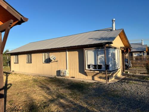 a house with a metal roof on top of it at Cabañas Campestres Inés in Chillán