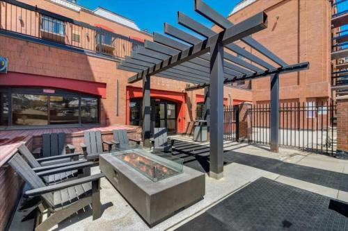 a patio with a fire pit in front of a building at Classic Ski-in Ski-out Condo in Park City