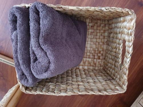 a wicker basket with a towel on top of it at Kalysandria Home in Padasul