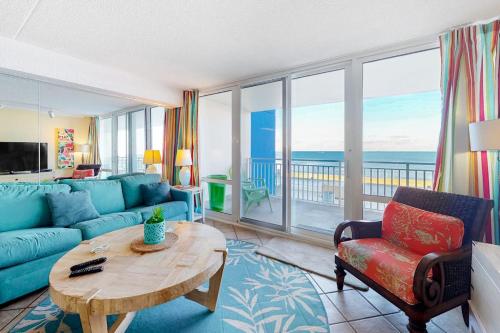 a living room with a blue couch and a table at Carousel 706 in Ocean City