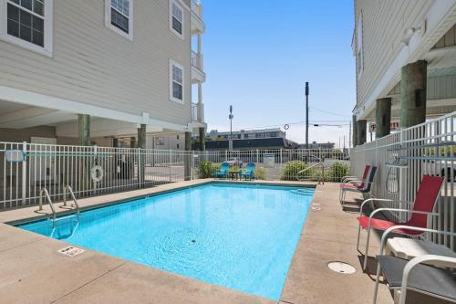 a swimming pool in front of a building at 16 The Palms in Ocean City