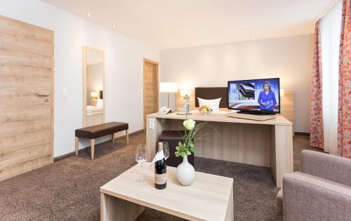 a hotel room with a desk with a laptop on it at Hotel Pfälzer Wald in Bad Bergzabern