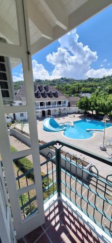 a balcony with a view of a swimming pool at Studio Suite 11 in Ocho Rios