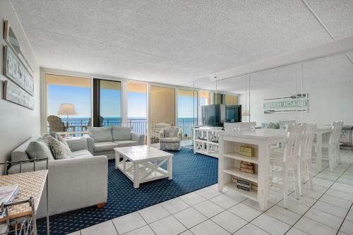 a living room with a couch and a table and a kitchen at Carousel 1605 in Ocean City