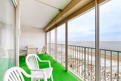 a balcony with white chairs and a view of the beach at English Towers 804 in Ocean City