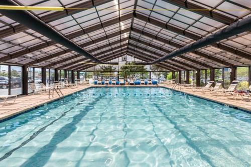 a large swimming pool with chairs and a ceiling at English Towers 804 in Ocean City