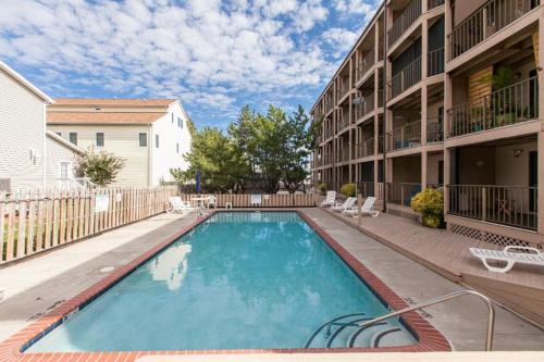 a swimming pool in the courtyard of a apartment building at Jamaica Bay 105A in Ocean City