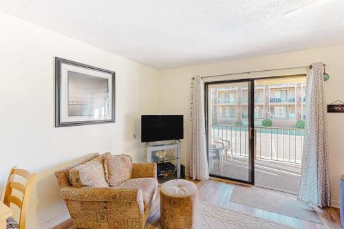 a living room with a couch and a tv and a window at Jamaica Bay 105A in Ocean City