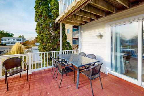a patio with a table and chairs on a porch at 604 Seaweed Lane #1 in Ocean City