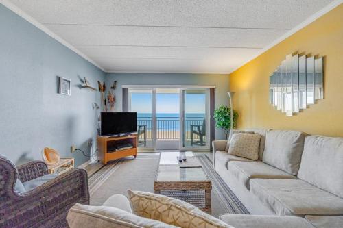 a living room with a couch and a television at Salty Sands in Ocean City